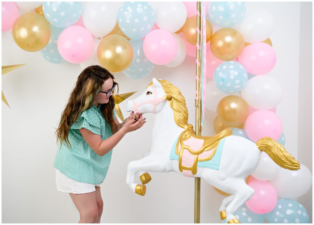 10 year old girl birthday photo with carousel horse